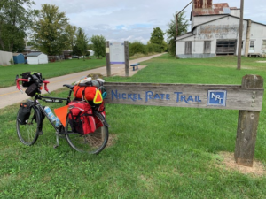 Touring bicycle parked in front of trail