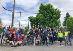 a group of bicyclists waving hi