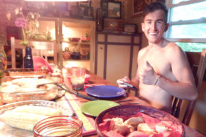 Man at dining table eating dinner