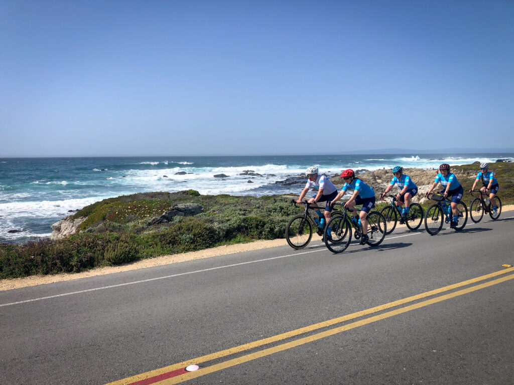 Bicycle riders riding along a coastal road