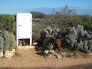 refrigerator on the side of the road out in the middle of nowhere