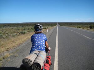 Woman riding a bicycle on a deserted road