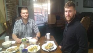 Two men eating dinner