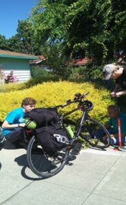 Two men fixing a flat tire on a bicycle