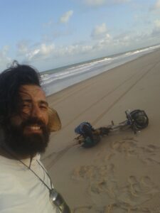 Man and bicycle on empty beach