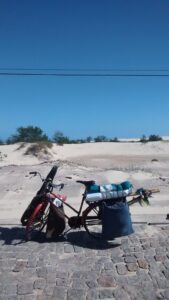 bicycle loaded for long distance touring parked on beach