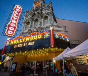 Movie theater marquee showing Filmed by Bike