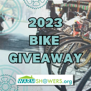 Bicycle wheels with words 2023 Bike Giveaway Warmshowers.org