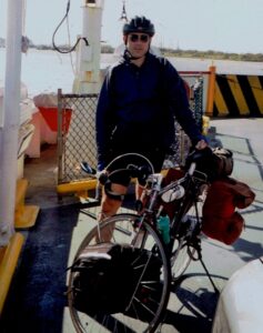 Man with fully loaded touring bicycle