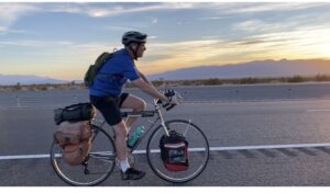 Man riding touring bicycle along the road