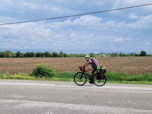 Woman riding a bicycle along a country road