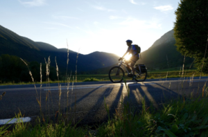 Person riding a bicycle on an scenic road