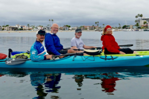 4 people kayaking in the bay