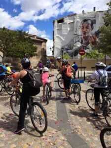 A group of bicyclists riding along a city street