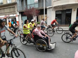 A group of bicyclists riding along a city street