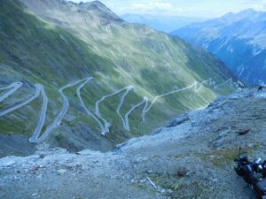 Picture of a zig zagging road on the side of a steep mountain.