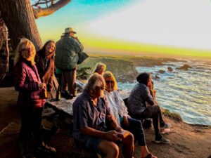 A group of people relaxing on the beach.