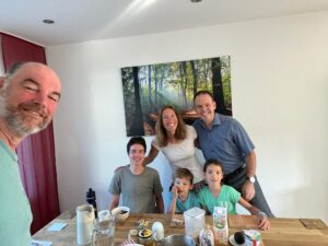 A group photo of a family eating dinner.