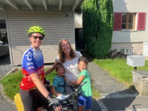 People posing with a touring bicyclists