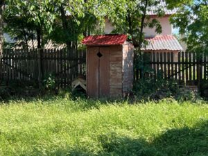 An outhouse in a family's backyard