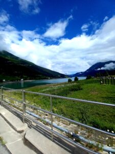 Blue sky, clouds, a lake and a meadow