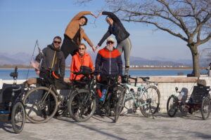 A group of touring bicyclists posing with their bicycles