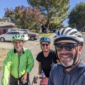 3 people posing with their loaded touring bicycles