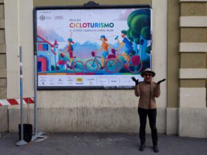 Woman standing in front of a banner for Cicloturismo