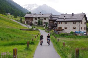 2 people riding bicycles on a trail in the Italian Alps