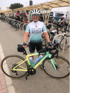 Cyclist posing with pastel bike at bike rack