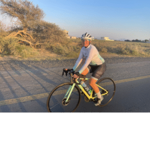 Cyclist riding pastel bike on open road