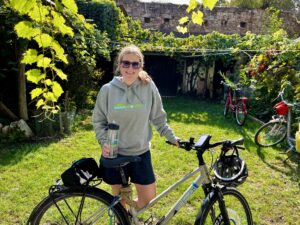 A person posing with their bicycle