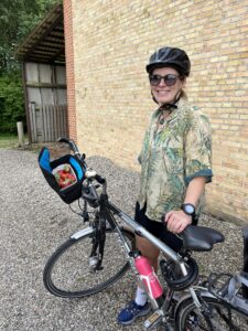 A person posing with their bicycle