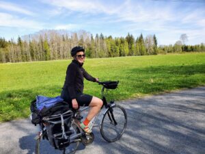 A person on a bicycle on a trail through the woods