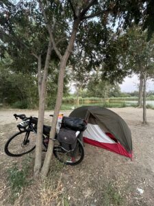 A touring bicycle next to a small tent