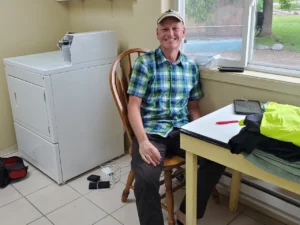 Man sitting at a table in a laundry room