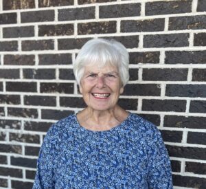 Woman standing in front of a brick wall