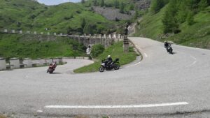 Motorcyclists racing down a winding road