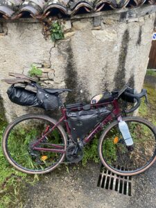 A bicycle leaning against a stone wall