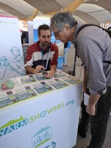 A person showing another something on his cell phone