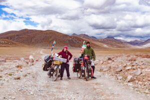 Two people and their touring bicycles on a rocky mountain trail