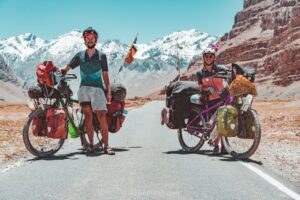 Two people and their touring bicycles on a mountain road